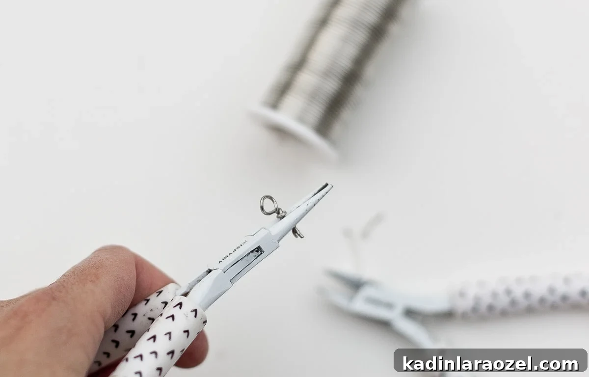 Twisting wire into an eye loop with a straight end for poking into clay.