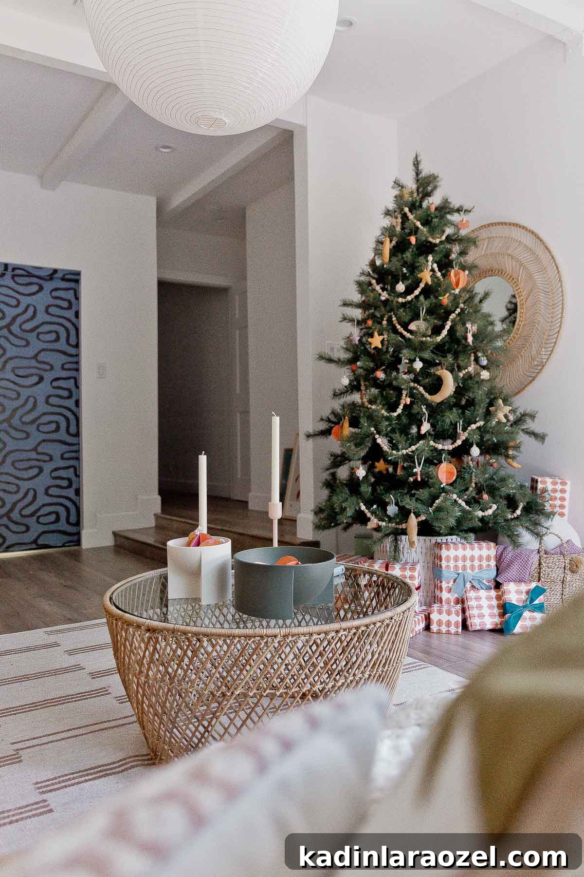 Large Christmas tree in the corner of a modern boho living room.