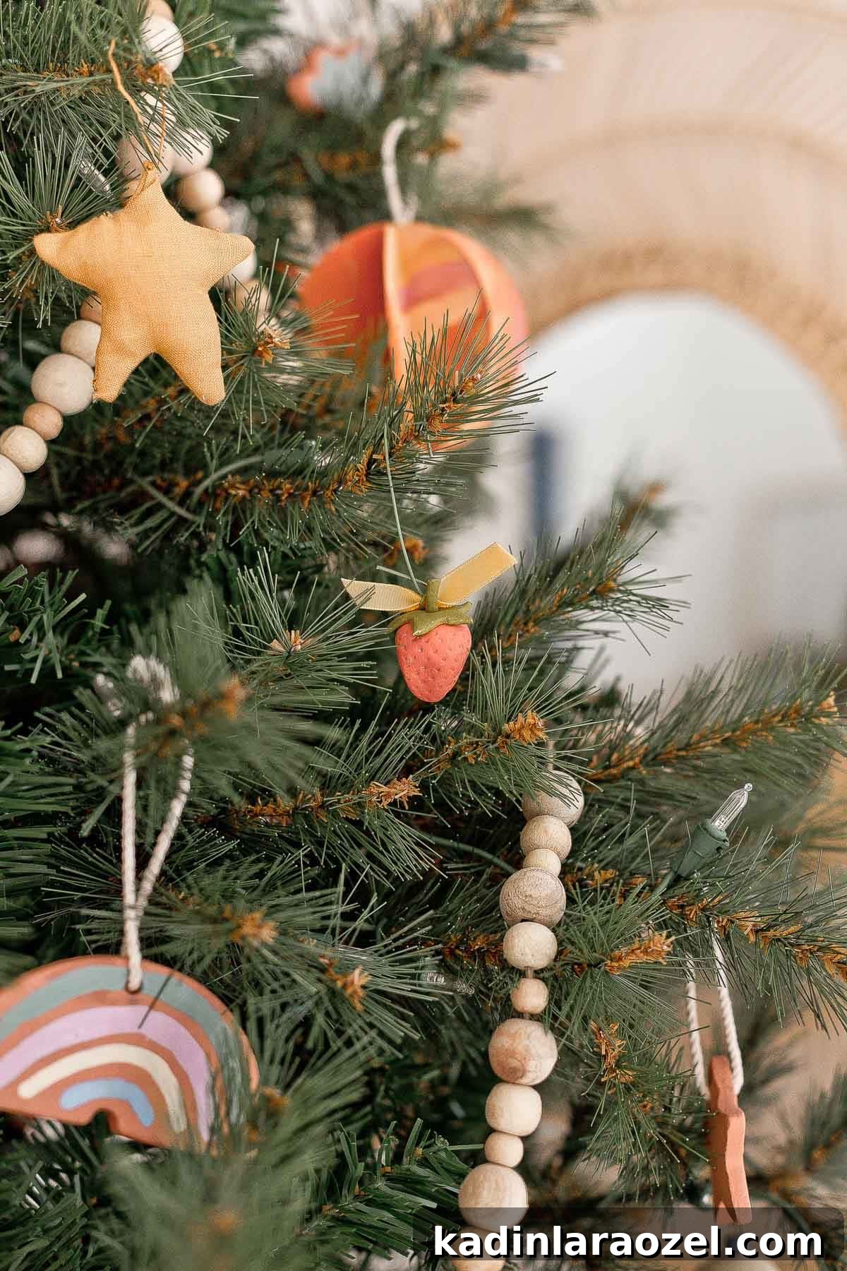 Closeup image of a Christmas tree with handmade ornaments and wood garland.