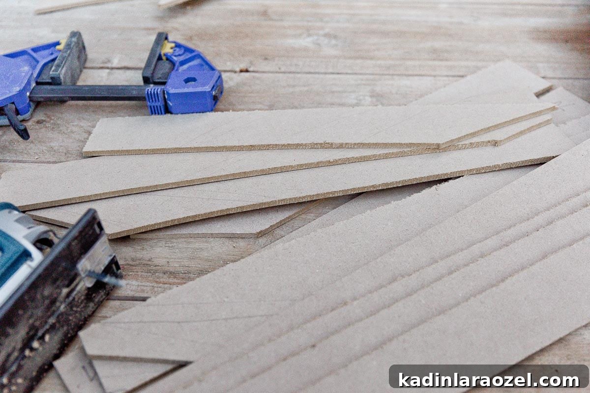 Statement-Making DIY King Size Half-Circle Headboard 7 Long strips of MDF panels, cut with a jigsaw, in a pile.