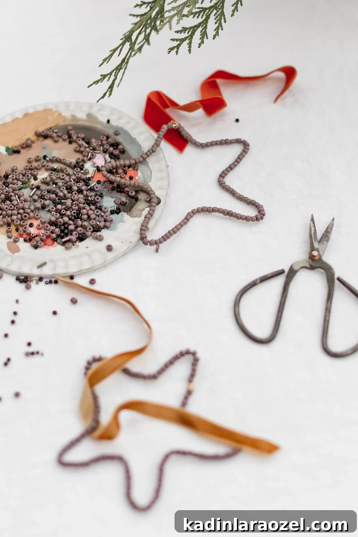 DIY Beaded Christmas Ornaments: Step-by-Step Holiday Craft Guide 6 Beaded ornaments (shaped like stars) with scissors and beads on the table.