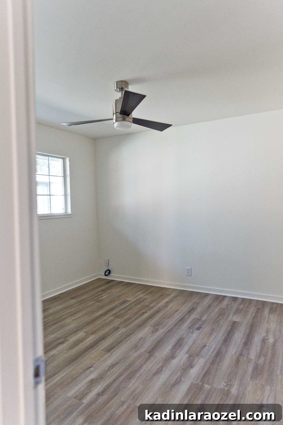 Photo of empty bedroom with modern ceiling fan.