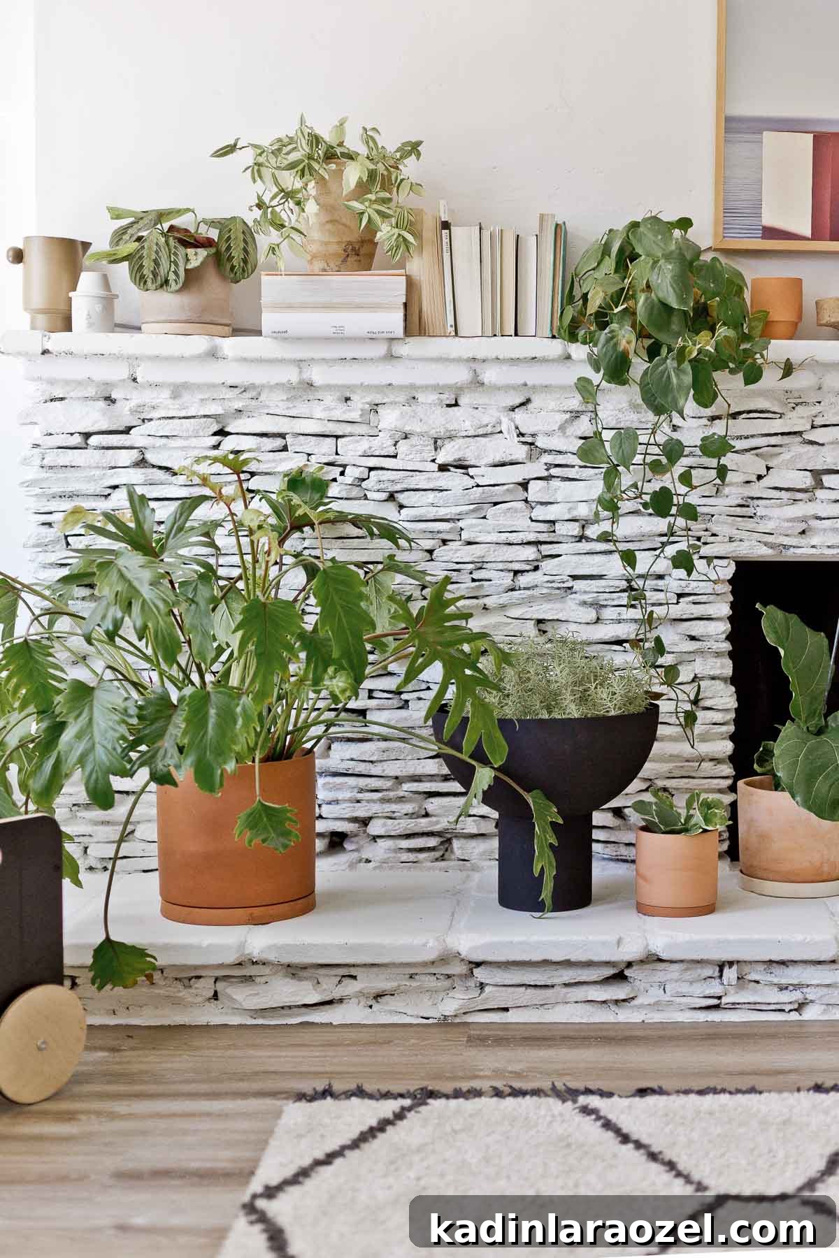 Fireplace Makeover Before & After: Stunning Transformations and Ideas 4 painted white stone fireplace with large plants and books