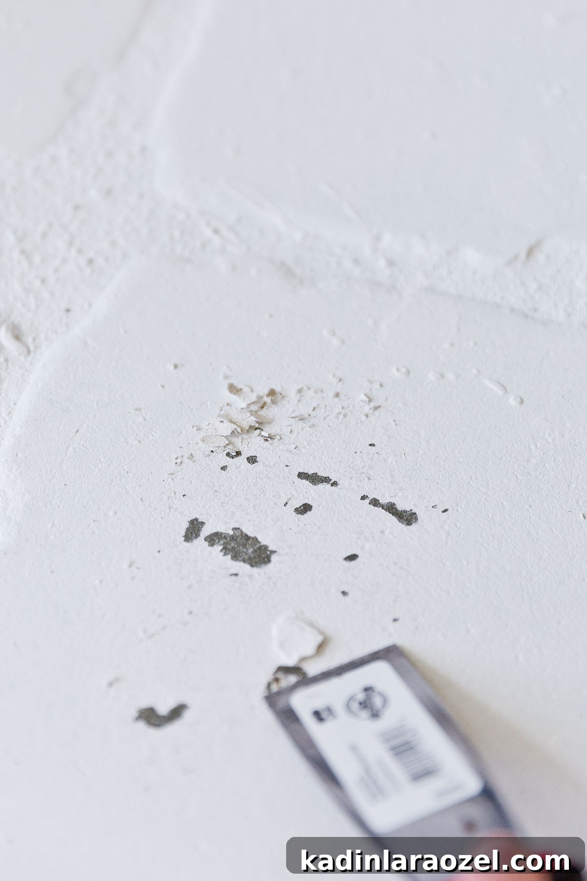 Fireplace Makeover Before & After: Stunning Transformations and Ideas 6 scraping paint drips off of white fireplace hearth, with a putty knife