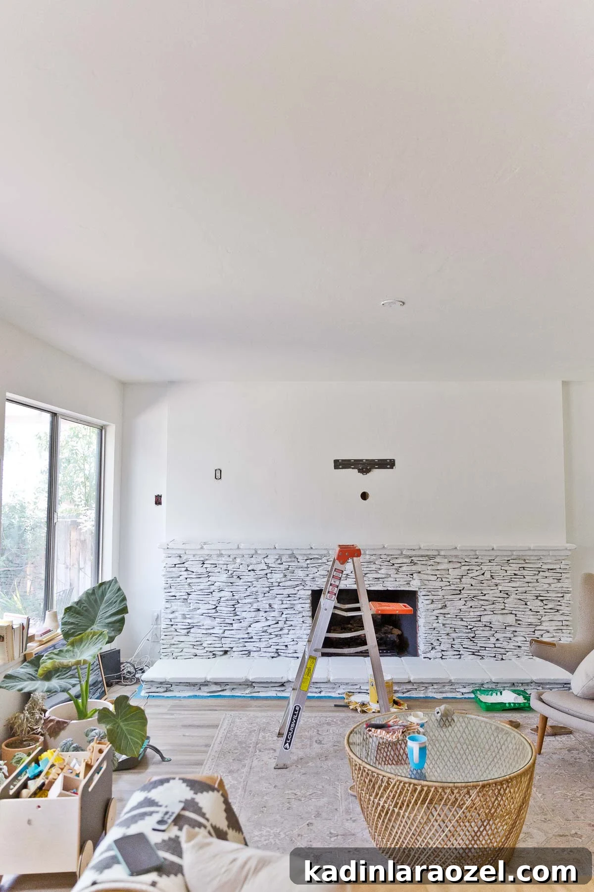 Fireplace Makeover Before & After: Stunning Transformations and Ideas 7 painted stacked stone fireplace with ladder in front of it