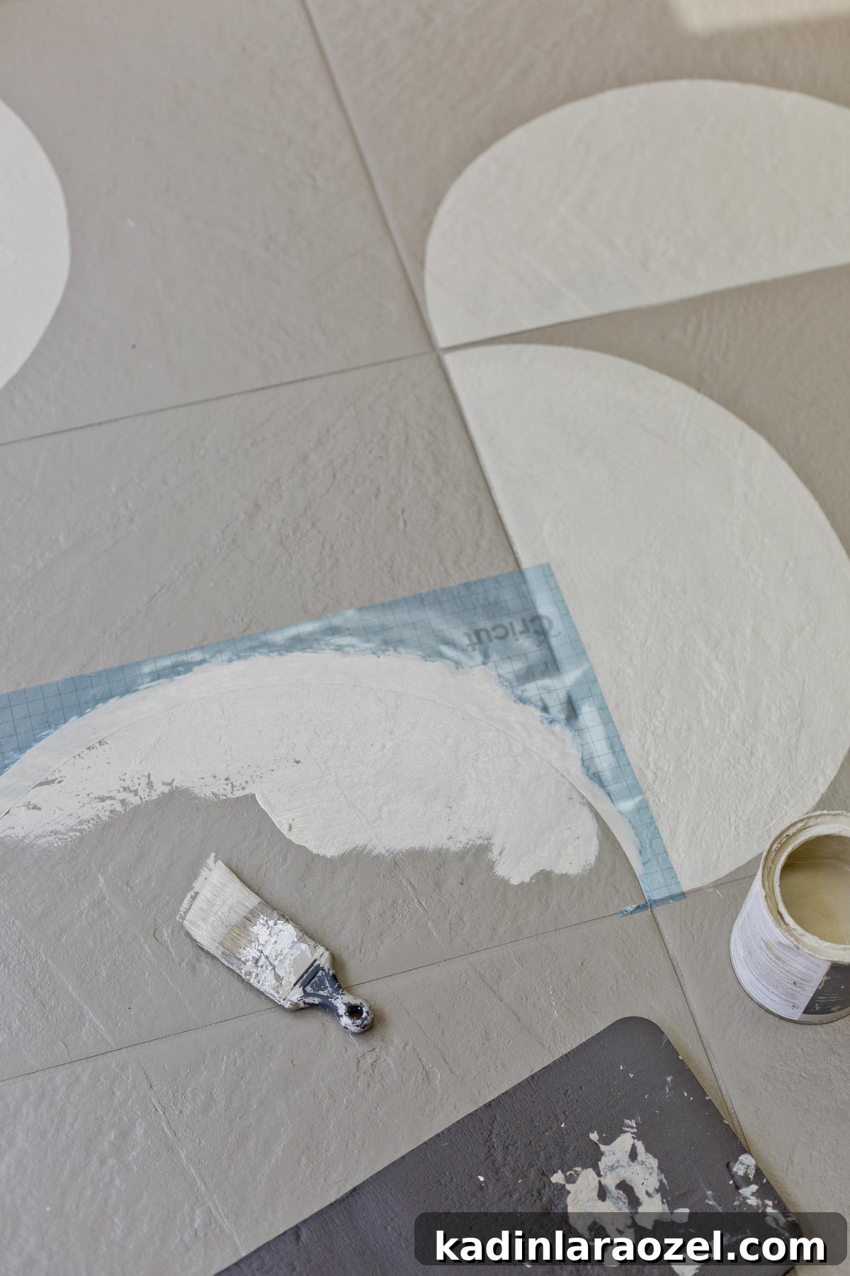 Porch Tile Painting Guide: Transform Your Floor in One Weekend 7 Painting floor tiles with a stencil and paint brush.