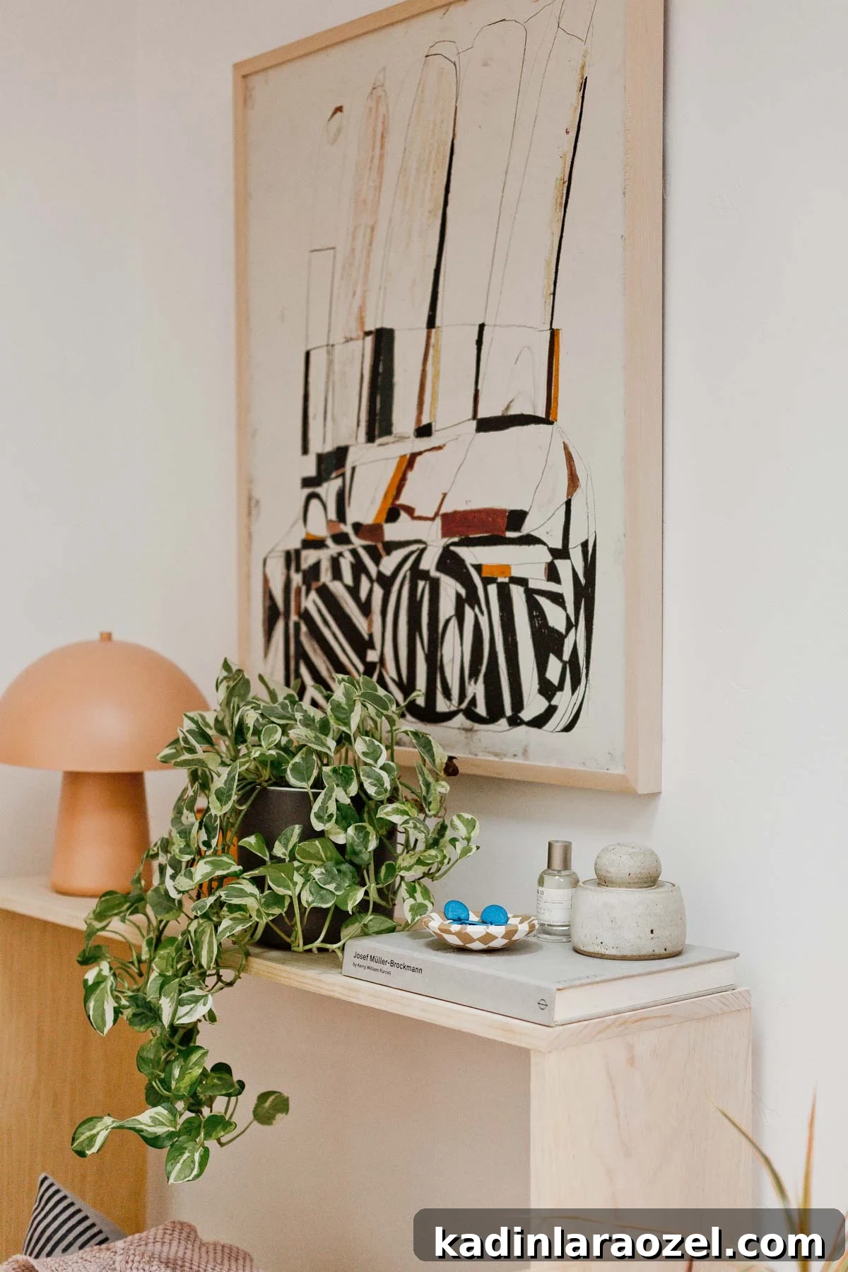 Minimal wood table with books and clay items.