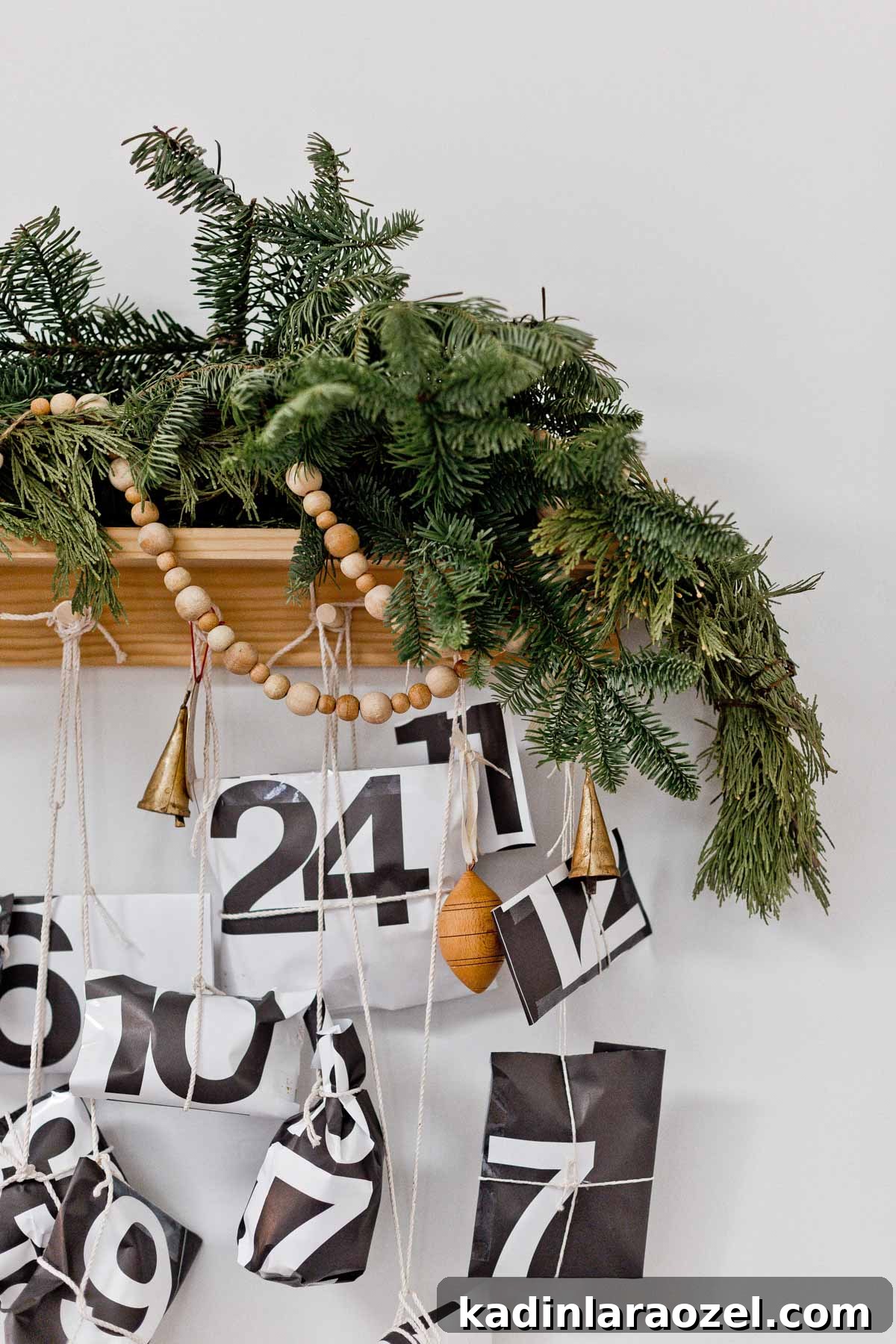 50 Advent Calendar Ideas to Delight Every Day in December 12 Small black and white packages hanging from advent calendar peg rail