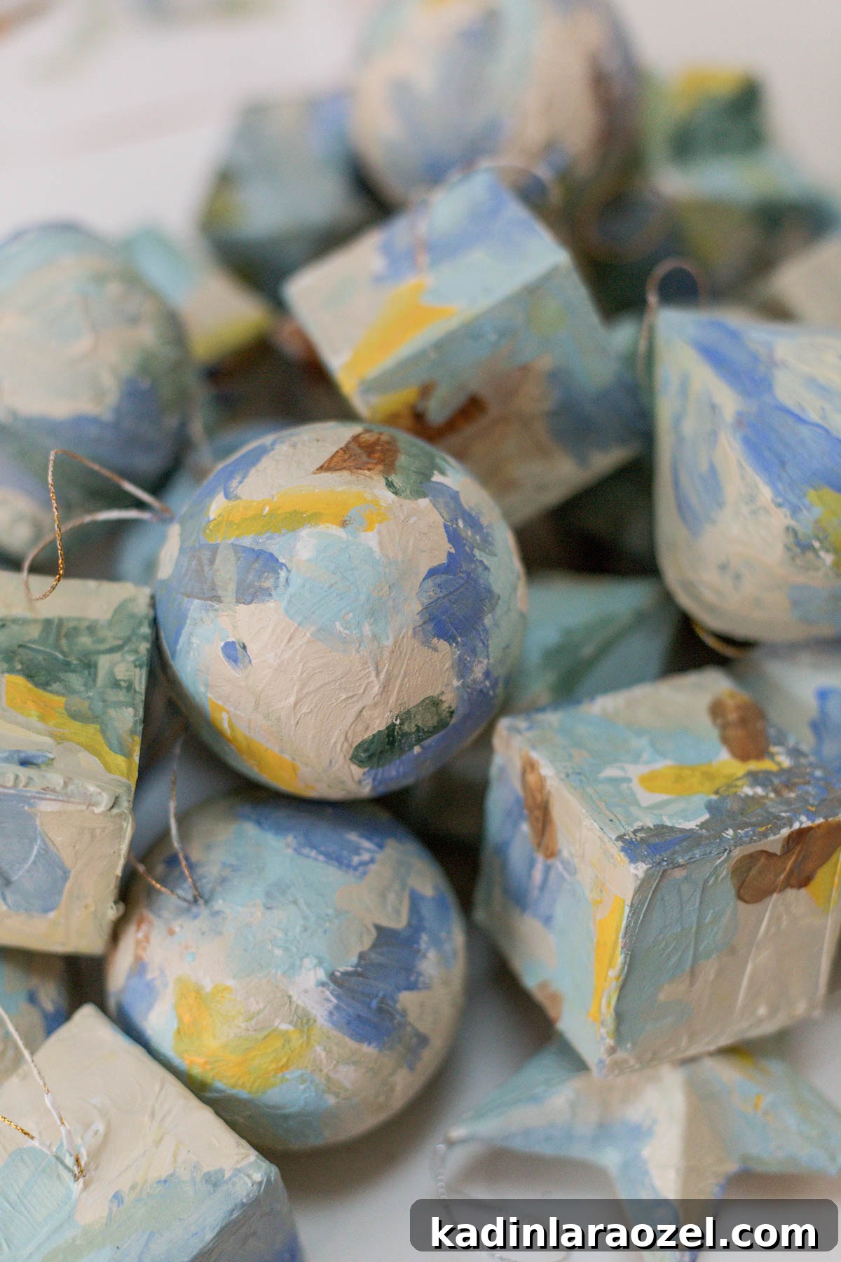 Paper cache ornaments painted and plastered with lots of texture