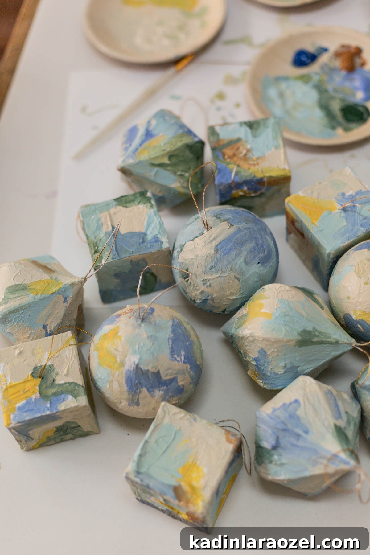 Abstract painted ornaments sitting on a table with paint