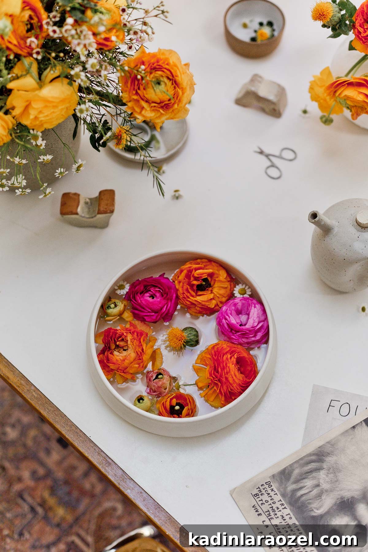 7 Pro Flower Arrangement Tips for Stunning Home Displays 11 Floating flowers in white ceramic bowl sitting on white and wood dining table