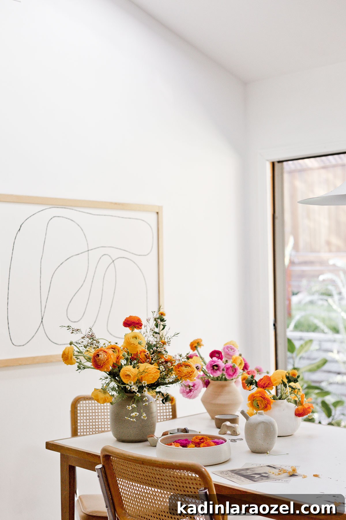 7 Pro Flower Arrangement Tips for Stunning Home Displays 8 Colorful flower arrangements on white dining room table with Cesca chairs