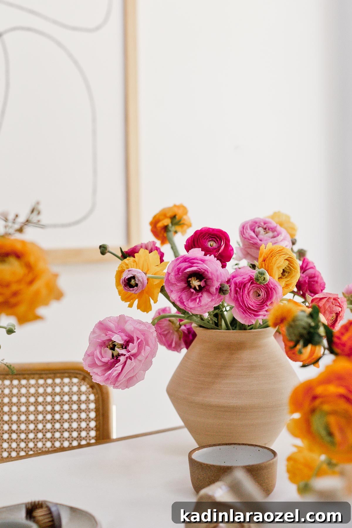 7 Pro Flower Arrangement Tips for Stunning Home Displays 9 Colorful ranunculus in neutral vase on a white table