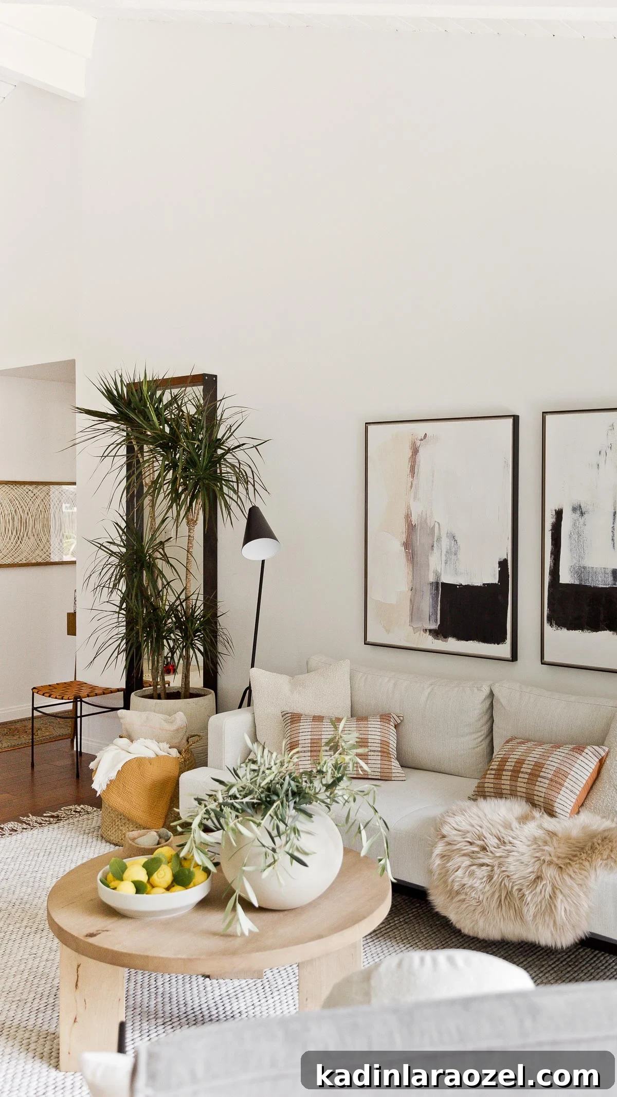 All white living room with wood accents and abstract artwork