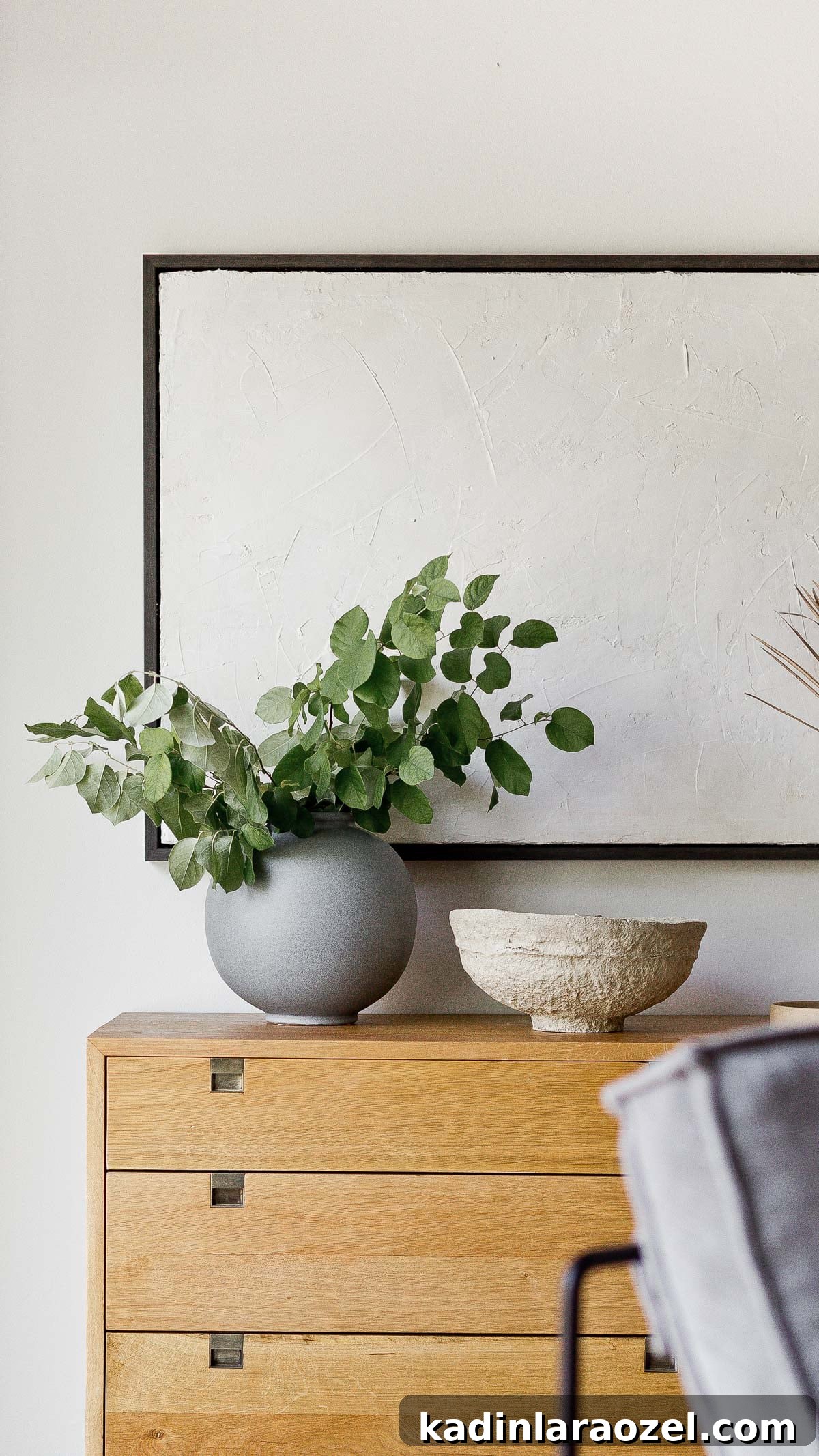 Organic modern wood dresser with gold accents in a light-filled living room