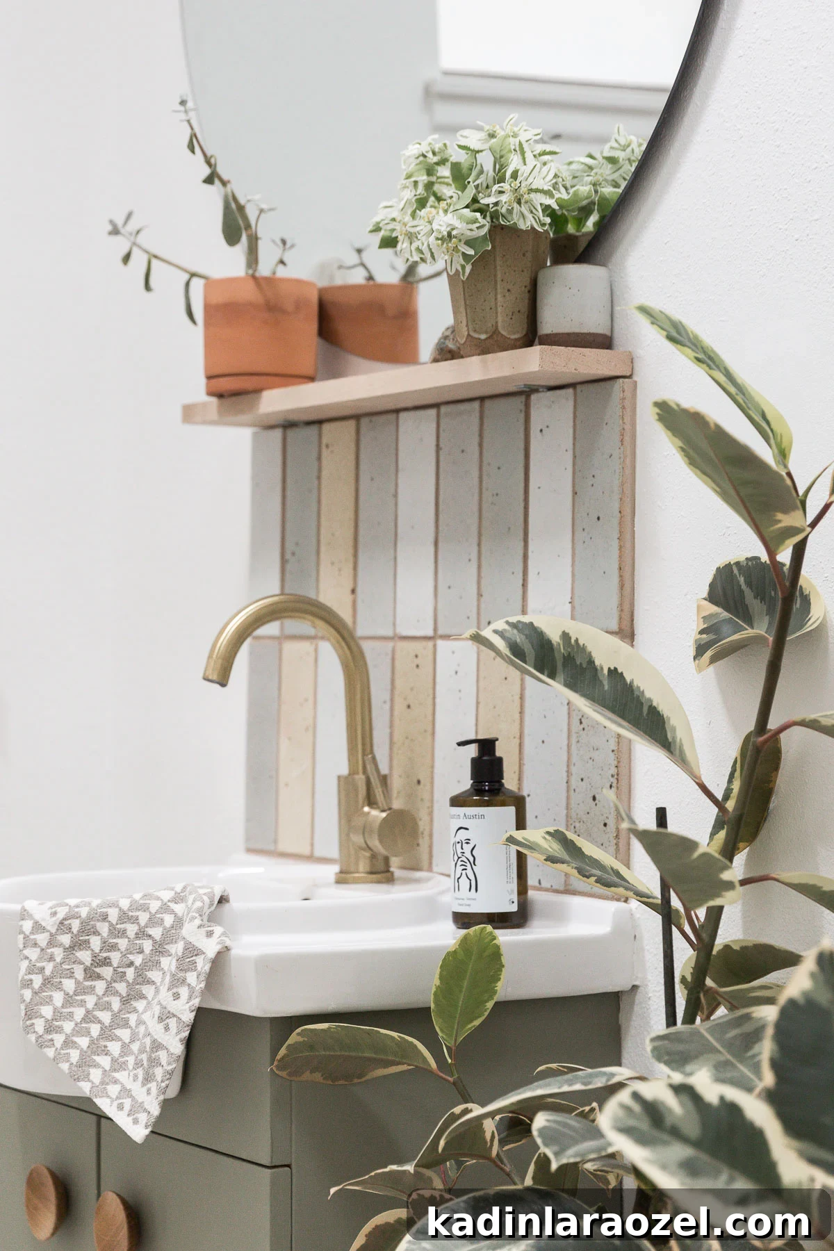 Small Bathroom Makeovers on a Budget: Before and After Ideas 9 Backsplash with handmade tiles in small bathroom, with gold accents and a green painted vanity