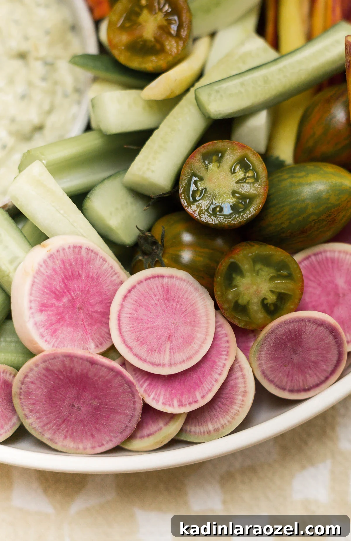 Atomic chery tomatoes, watermelon radishes, and cucumbers in a veggie platter.