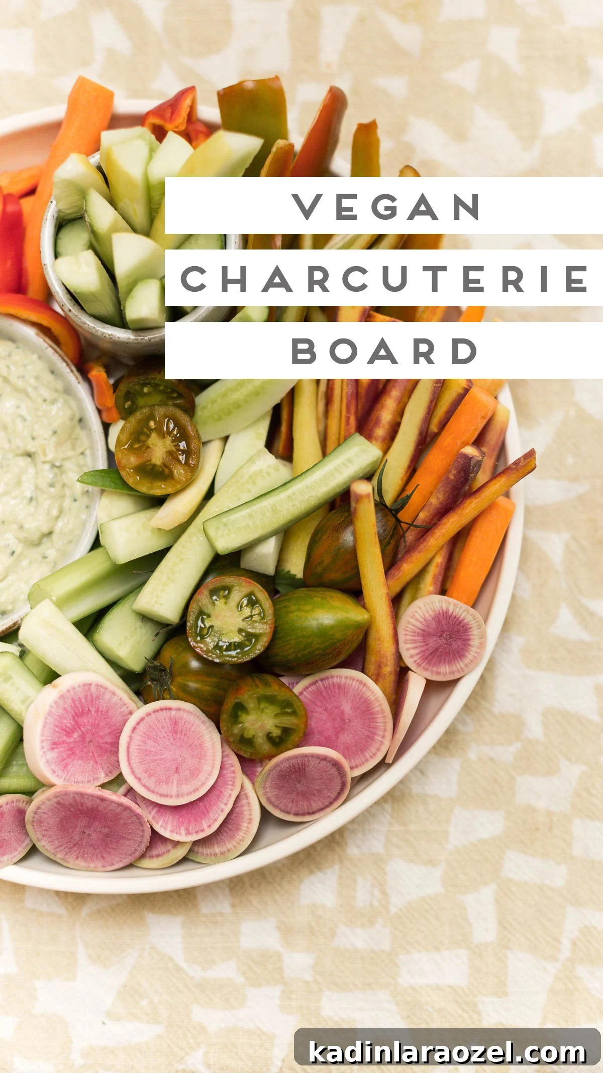 Large vegetable platter with hummus on a yellow checkered tea towel
