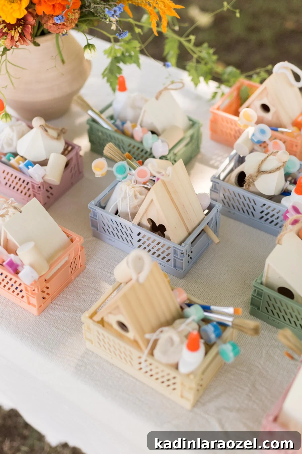 Birdhouse Craft Kits for Kids Party Favors 2 Pastel crates with birdhouse crafting kits inside, on a white table.