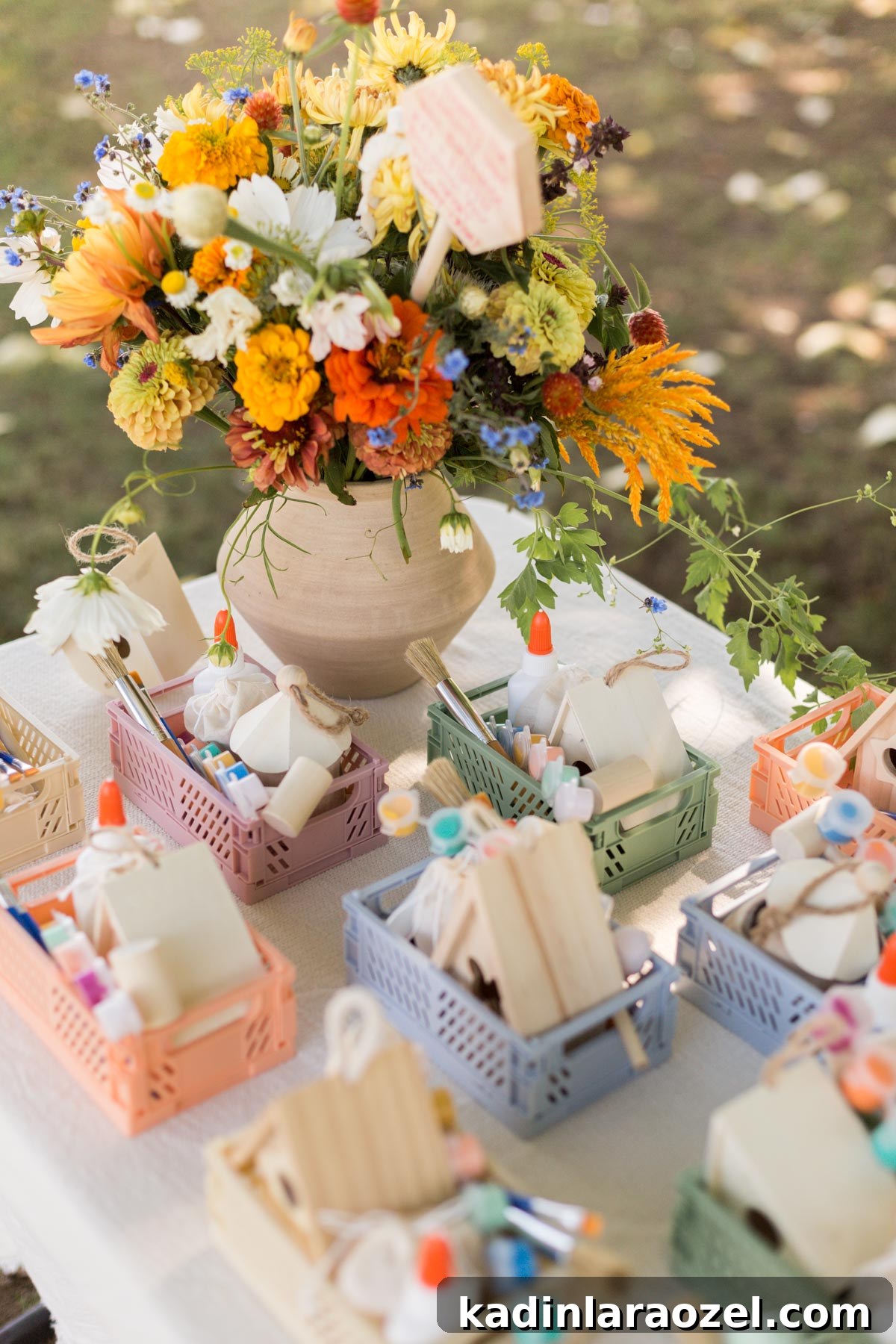Birdhouse Craft Kits for Kids Party Favors 6 Colorful flowers on a white table with pastel colors filled with all the supplies need to complete a birdhouse.
