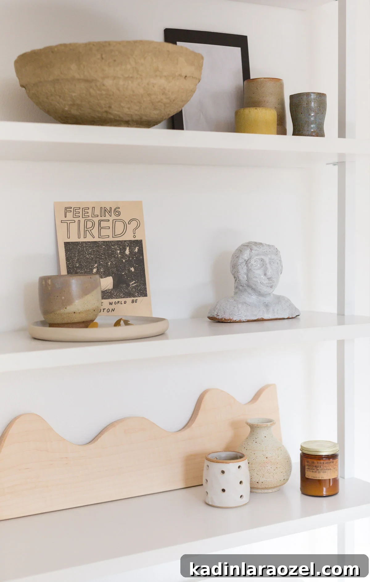 Closet Makeover: Transform Clutter Into a Stylish, Organized Space 2 White wall shelves styled minimally with ceramics and quirky artwork