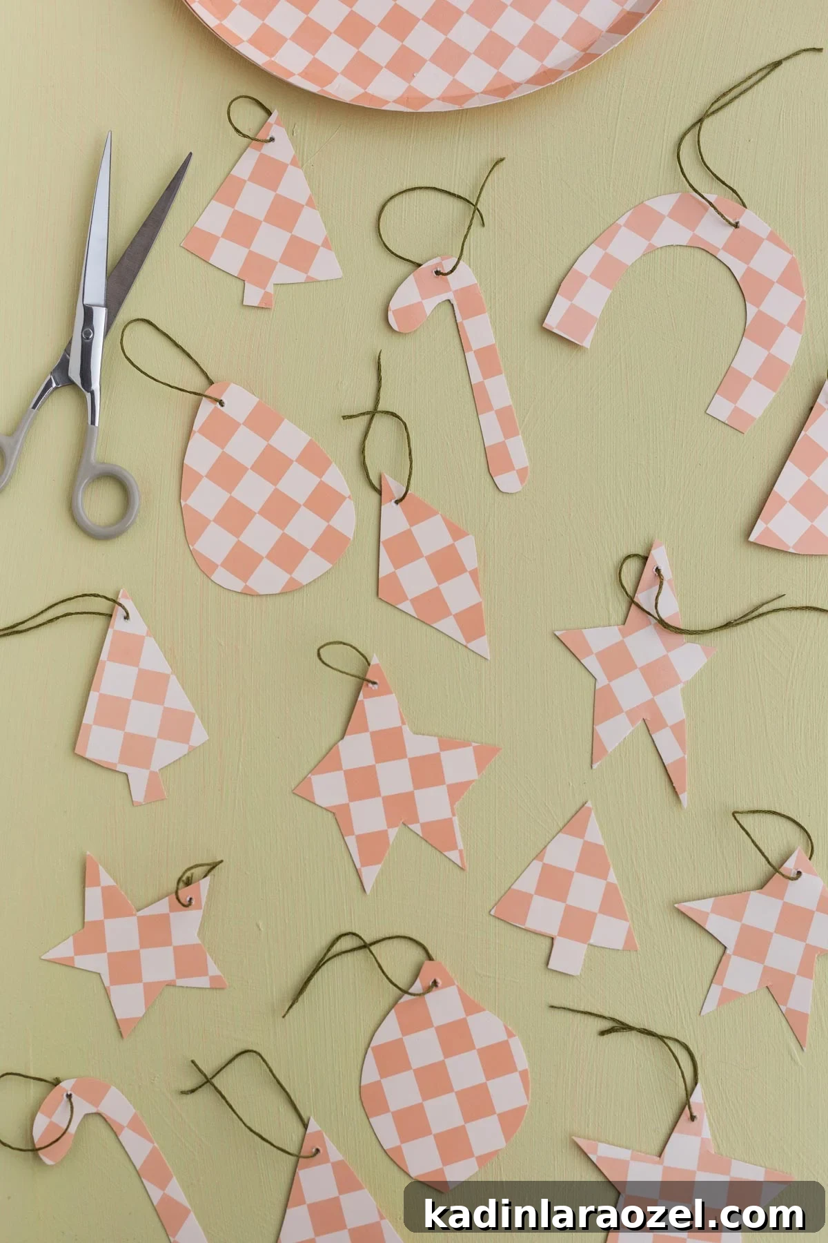 homemade checkered pattern paper ornaments on a green counter