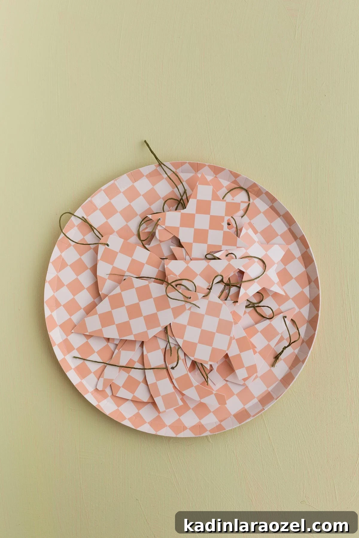 completed diy ornaments sitting on top of checkered paper plate