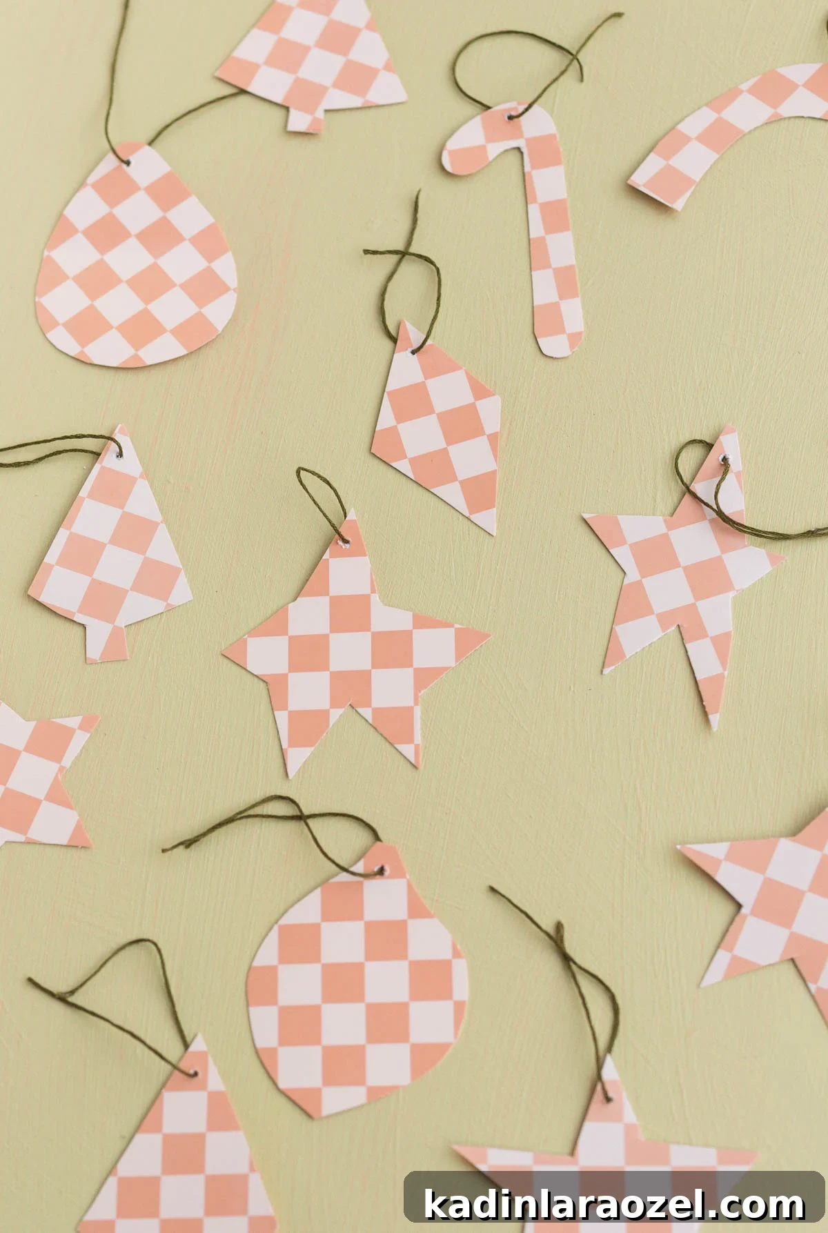 pink and white checkered ornaments in various shapes with olive green string