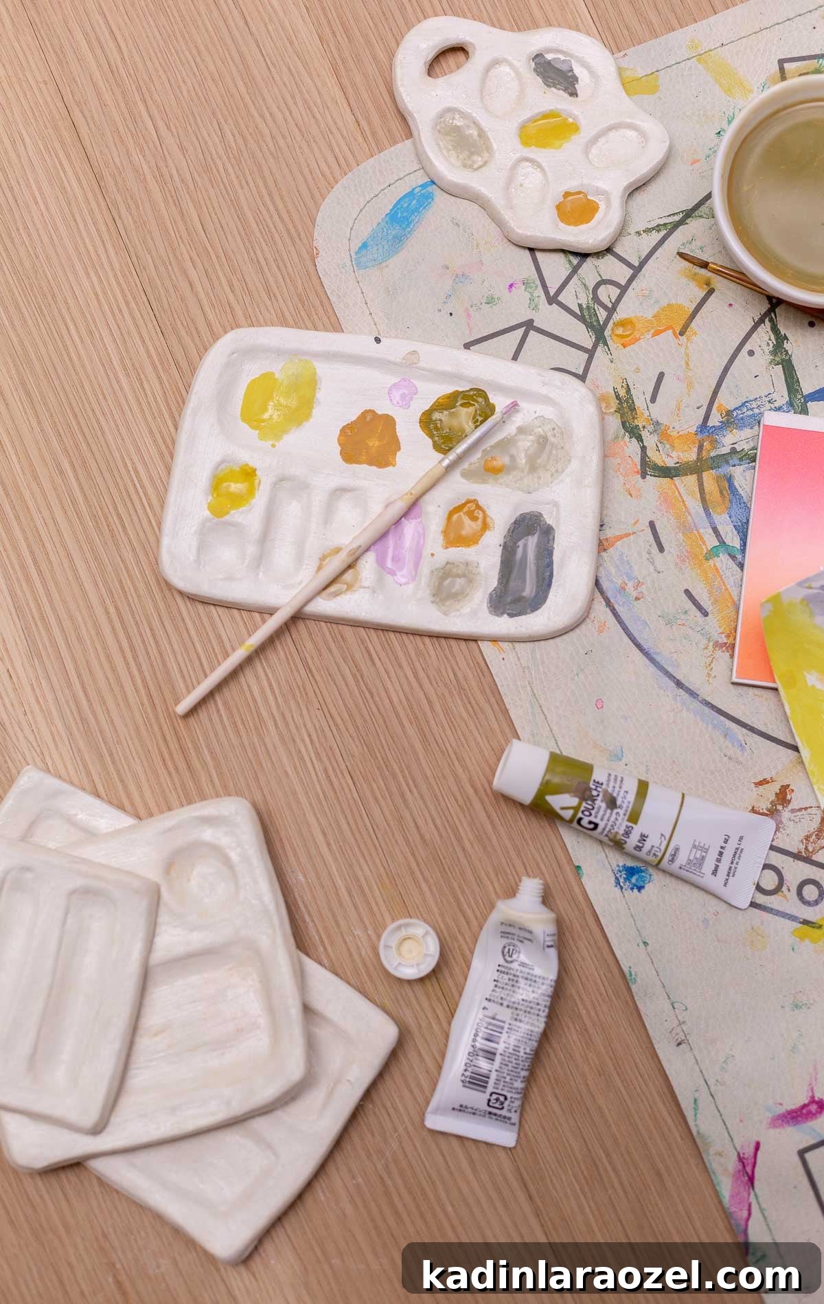 several handmade paint palettes on a table for kids