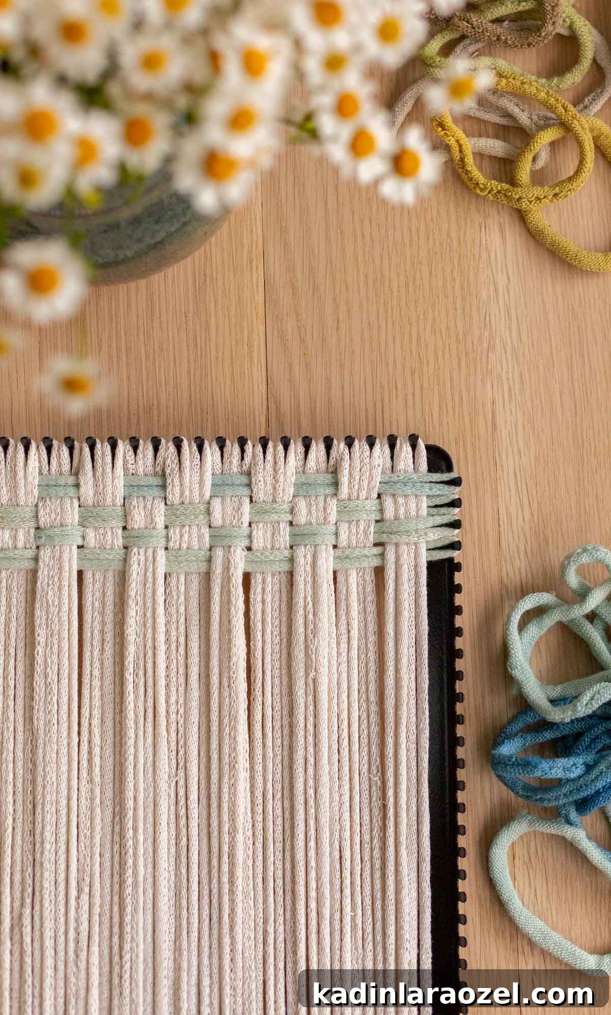 Potholder Loom Weaving: DIY Projects and Techniques 11 closeup of neutral weaving being made on pro size potholder loom, with hand dyed loops and flowers on the table