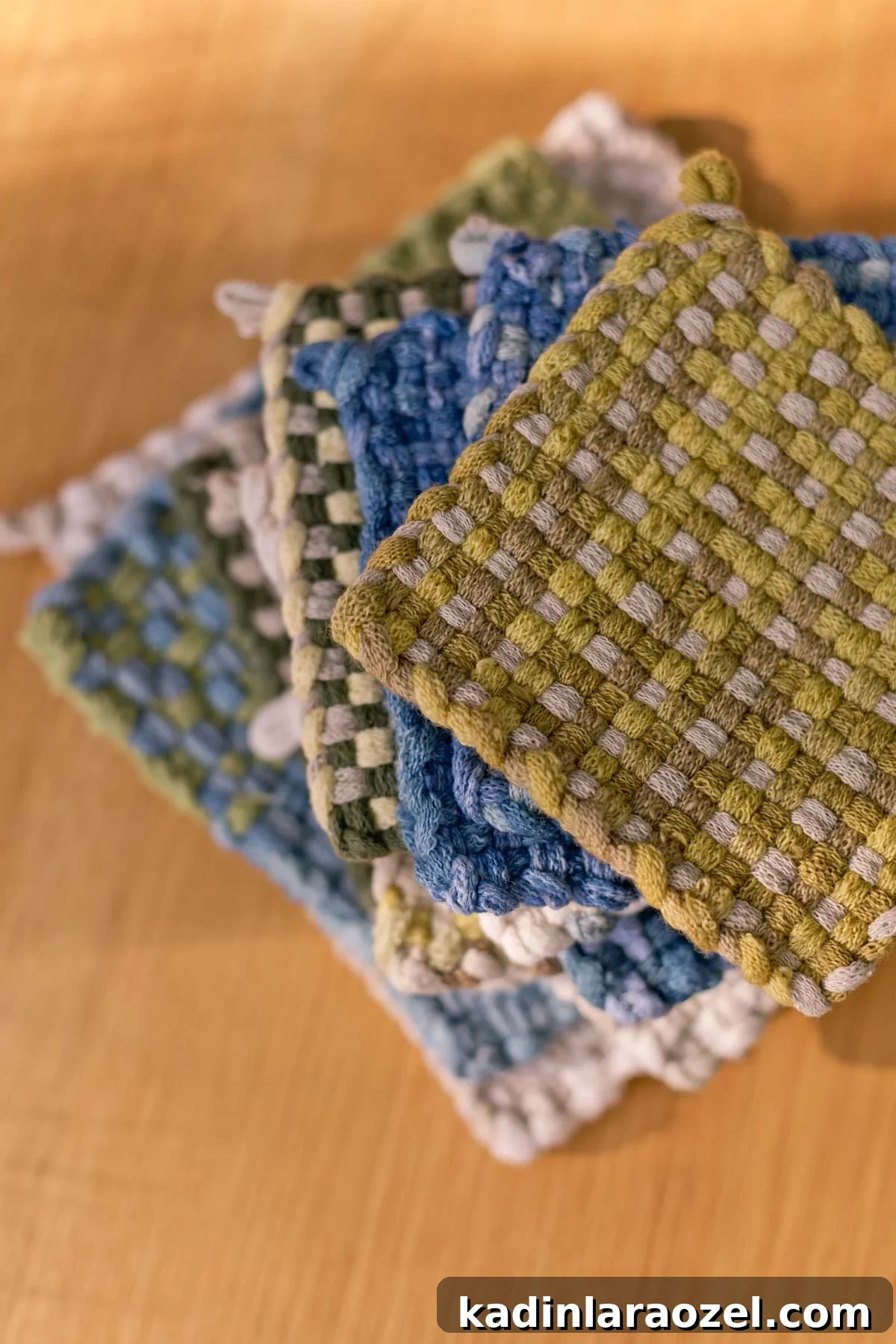 Potholder Loom Weaving: DIY Projects and Techniques 13 stack of woven potholders in earthy colors on a warm wood table