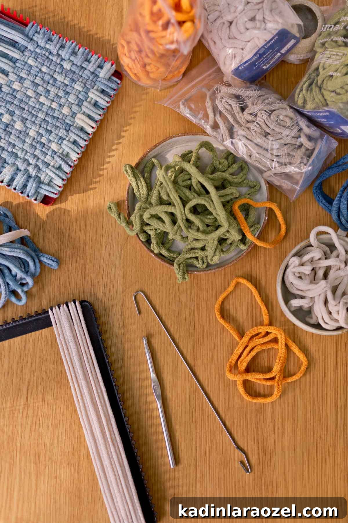 Potholder Loom Weaving: DIY Projects and Techniques 7 small weavings being made with two different size potholder looms, with colorful loops surrounding them on a table