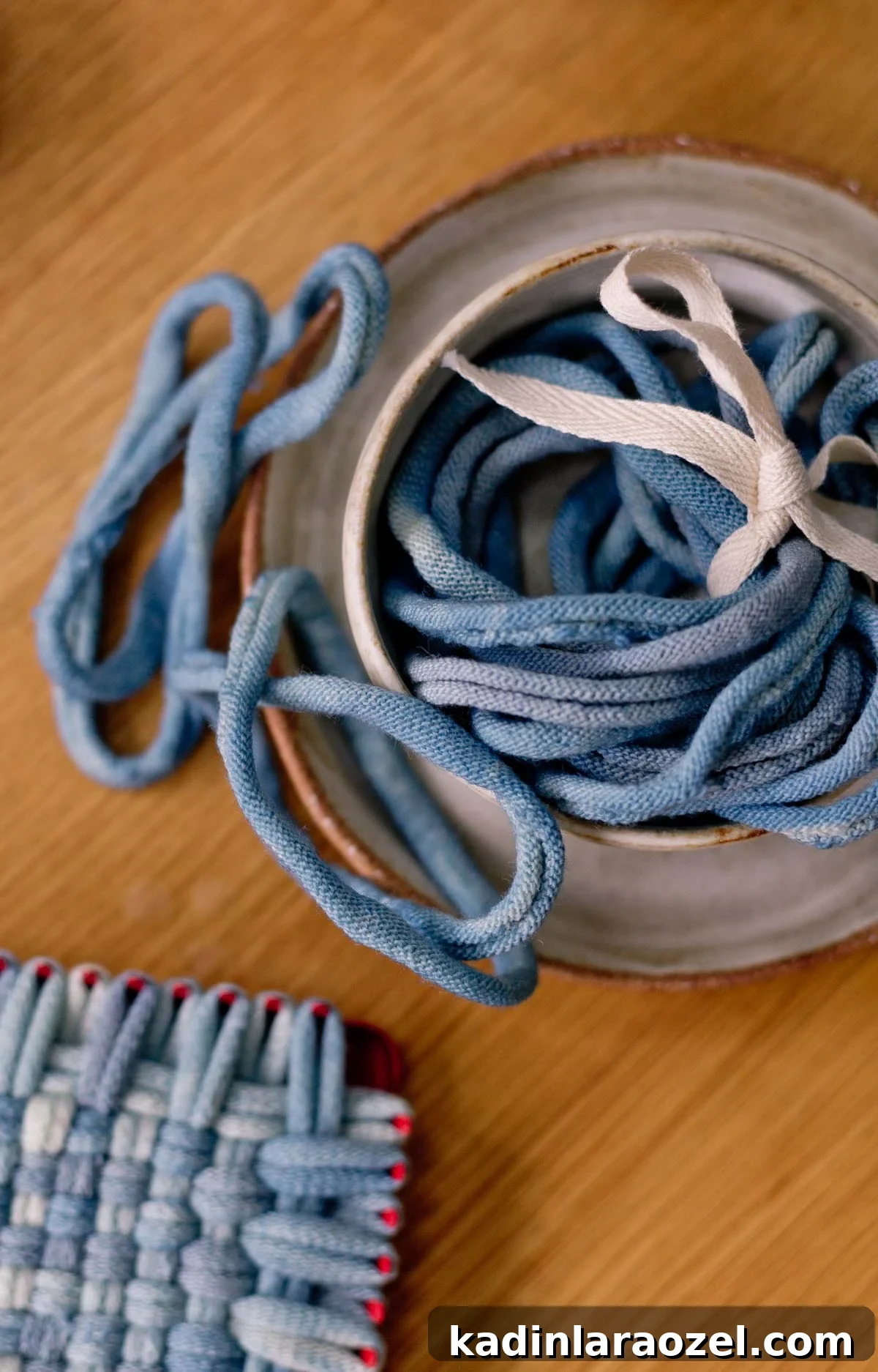 Potholder Loom Weaving: DIY Projects and Techniques 8 indigo blue potholder loops closeup in a ceramic container