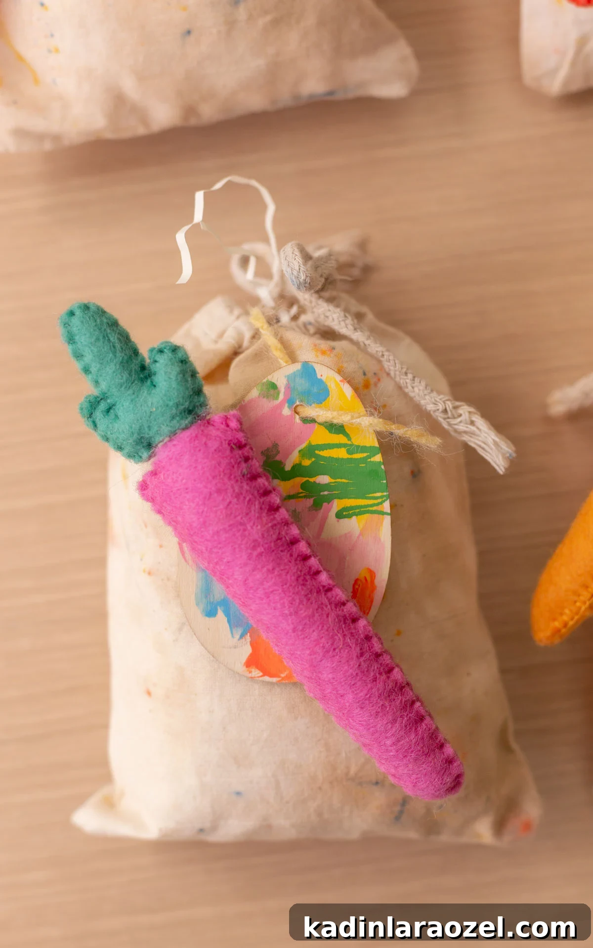 Drawstring canvas bags with colorful pink carrot on top and handprinted Easter egg tag