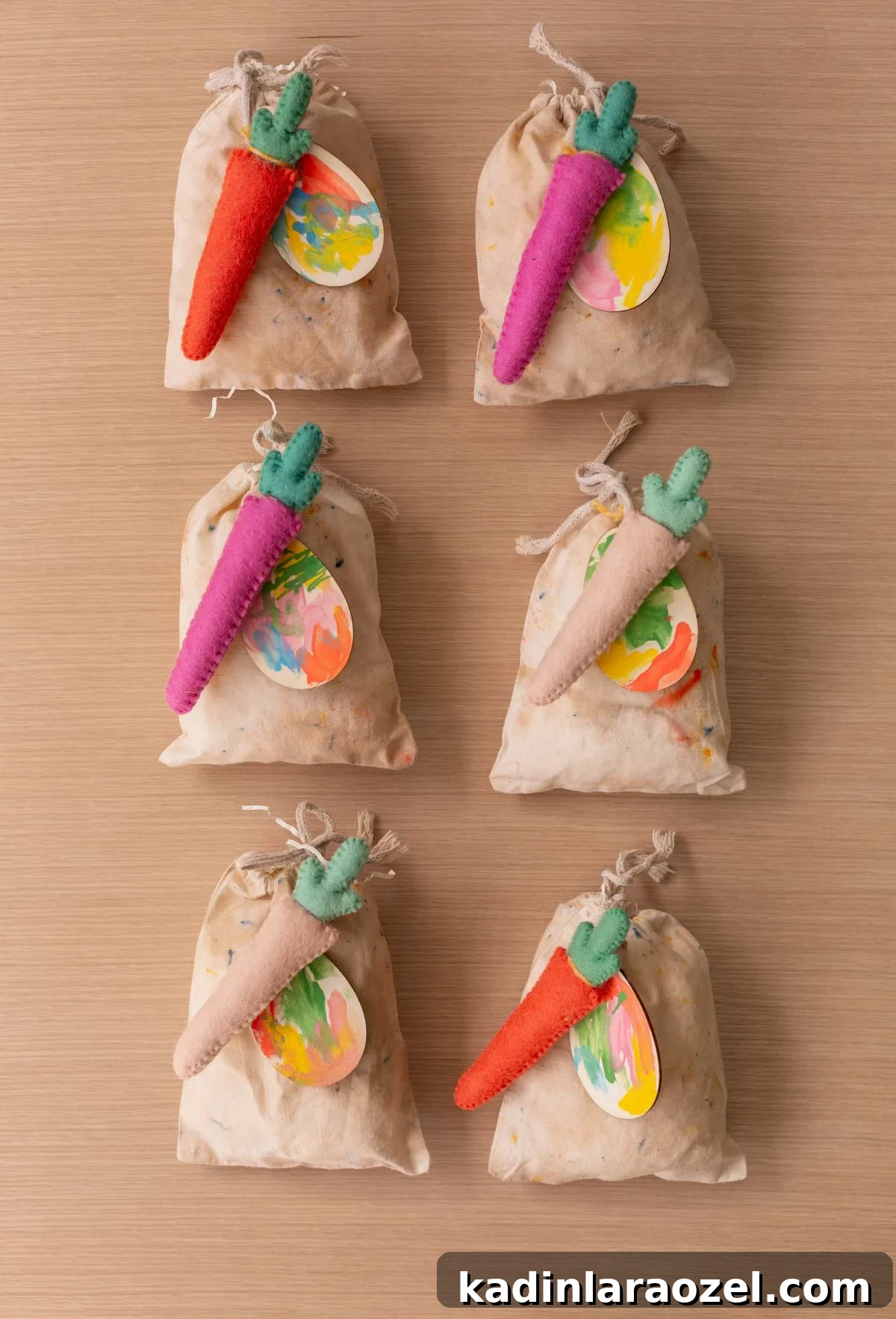 Easter goodie bags lined up on a table, with colorful carrots and Easter egg shaped gift tags