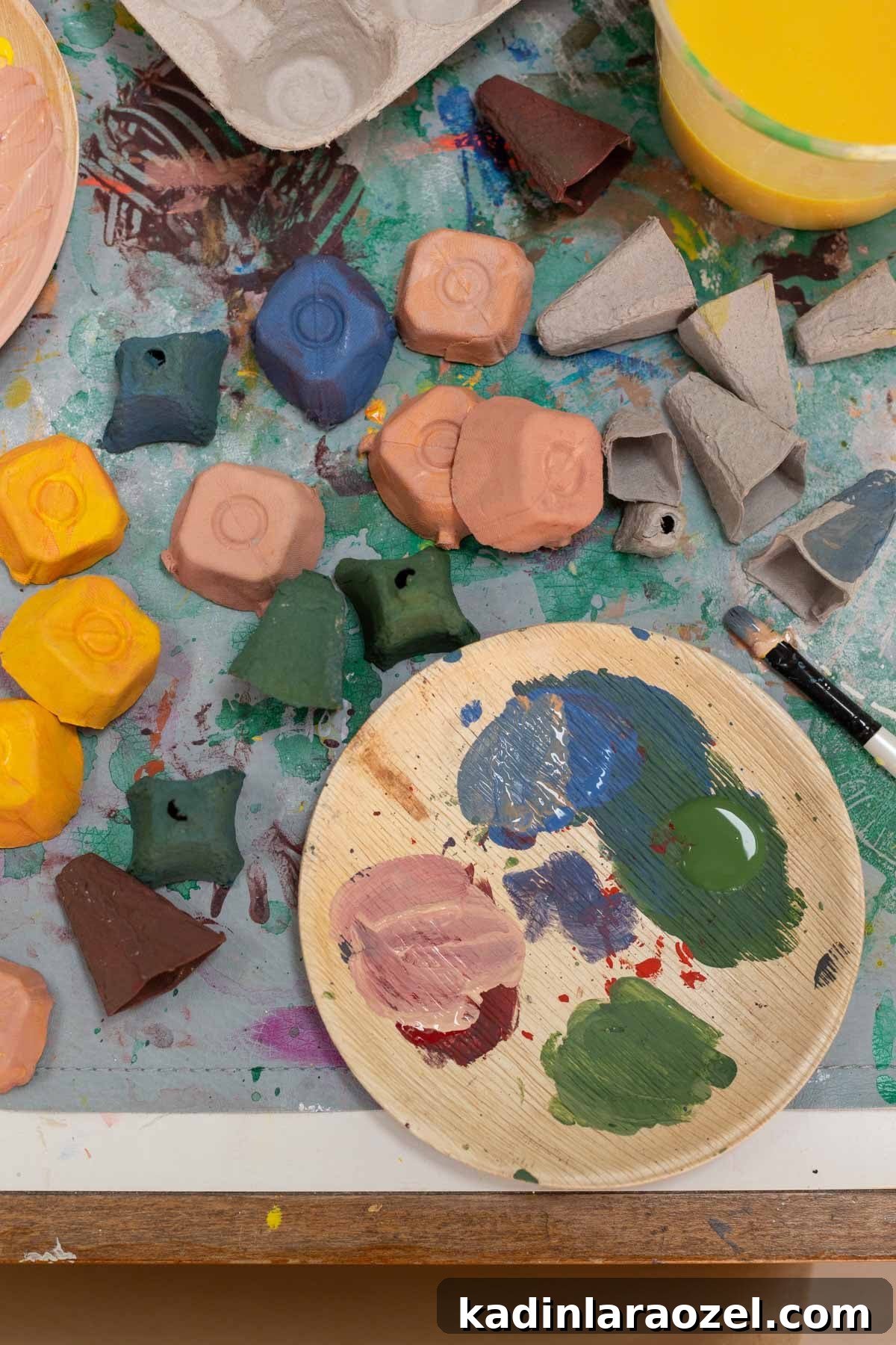 DIY Egg Carton Fish Craft: Make Colorful Fish from Egg Cartons for Kids 5 Painting small egg carton pieces in colorful, earthy paints