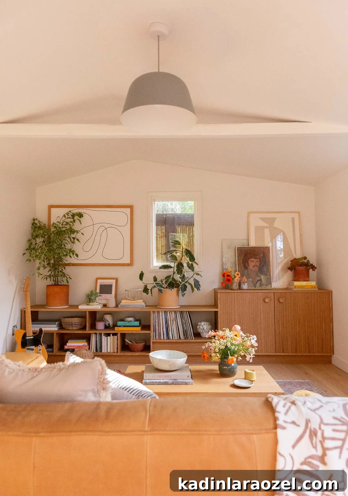 White room with vaulted ceilings and wall to wall wood cabinetry in a mid-century style