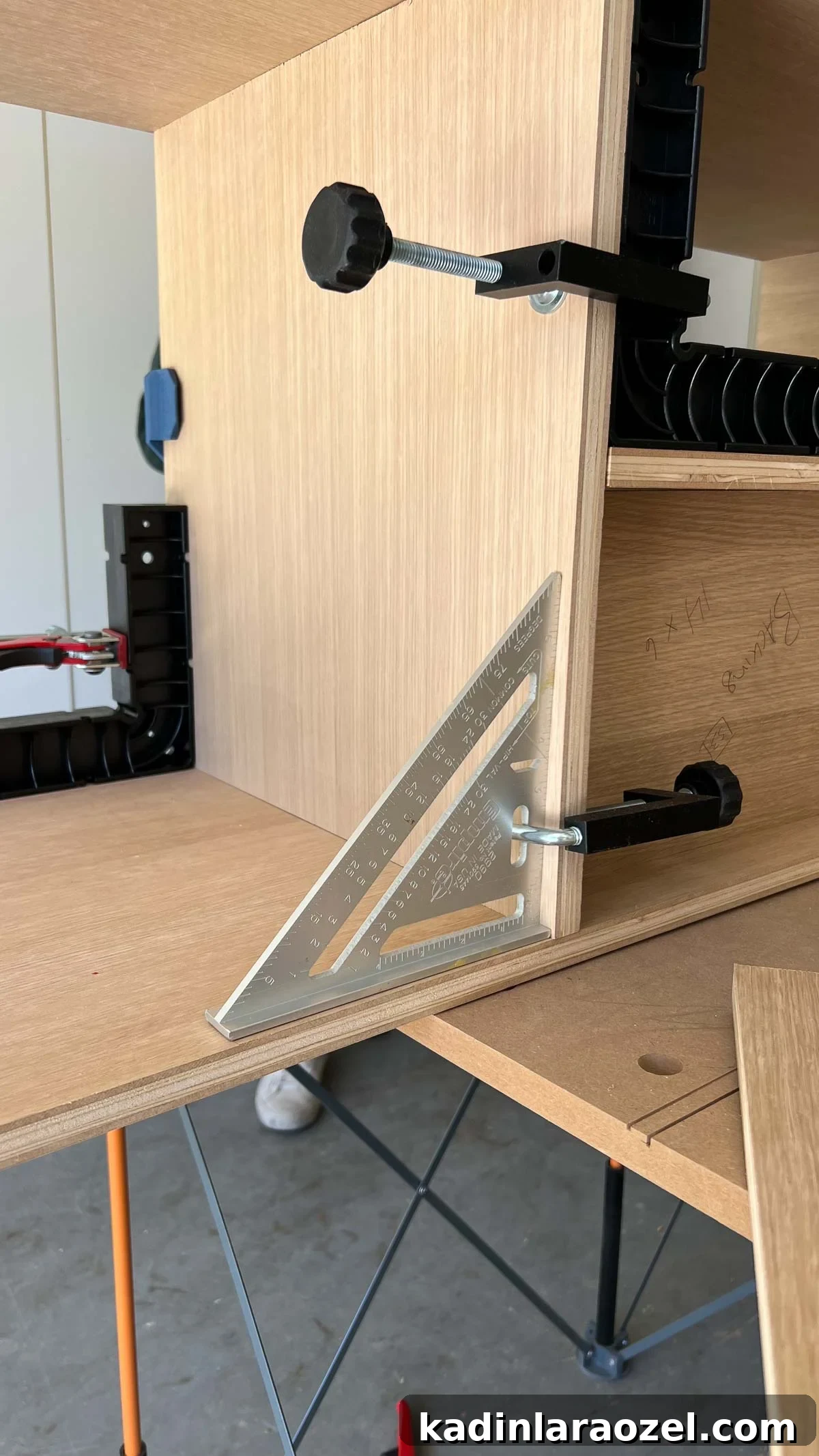 White oak built-in being made, with carpenter squares on a work surface
