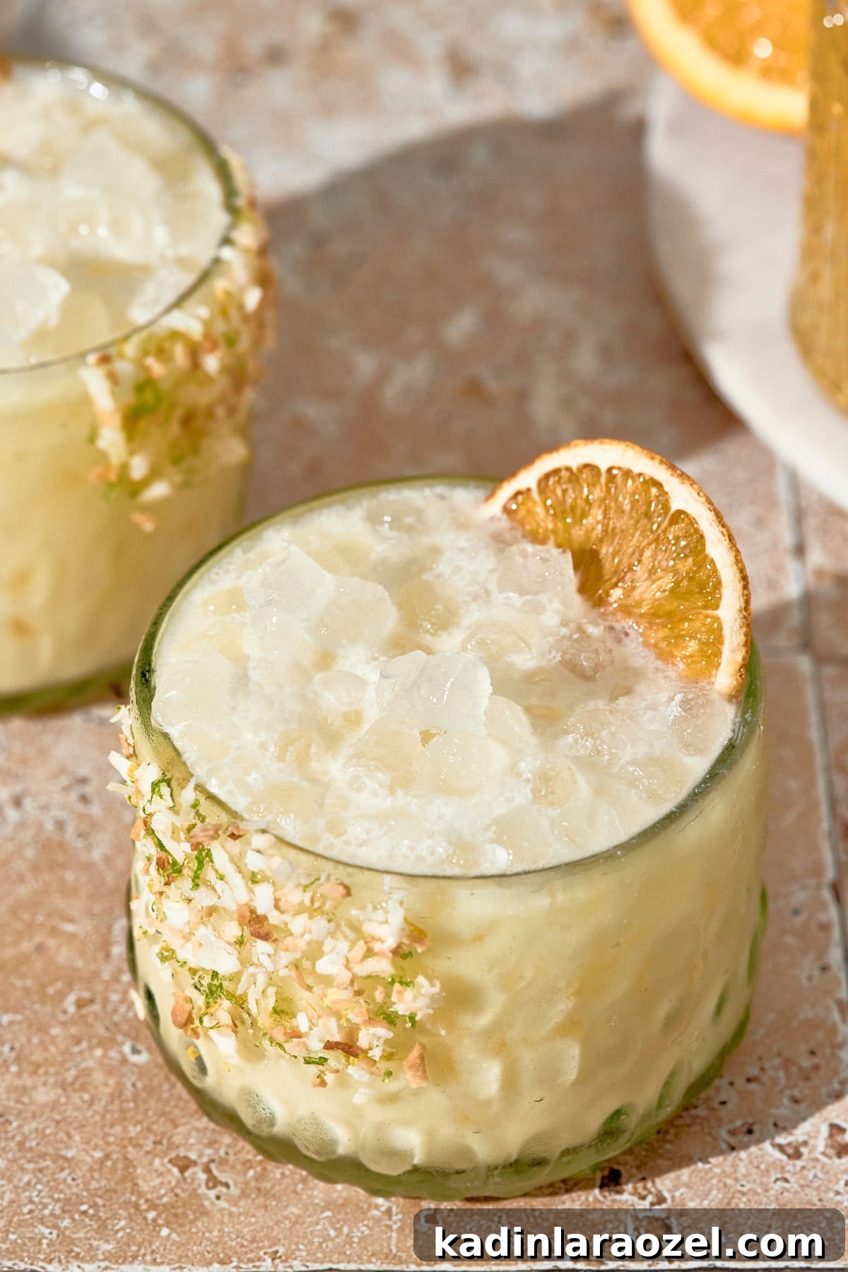 17 Refreshing Summer Cocktails to Try Now 5 orange creamsicle summer cocktail with nugget ice, in a short glass, and orange slice garnish