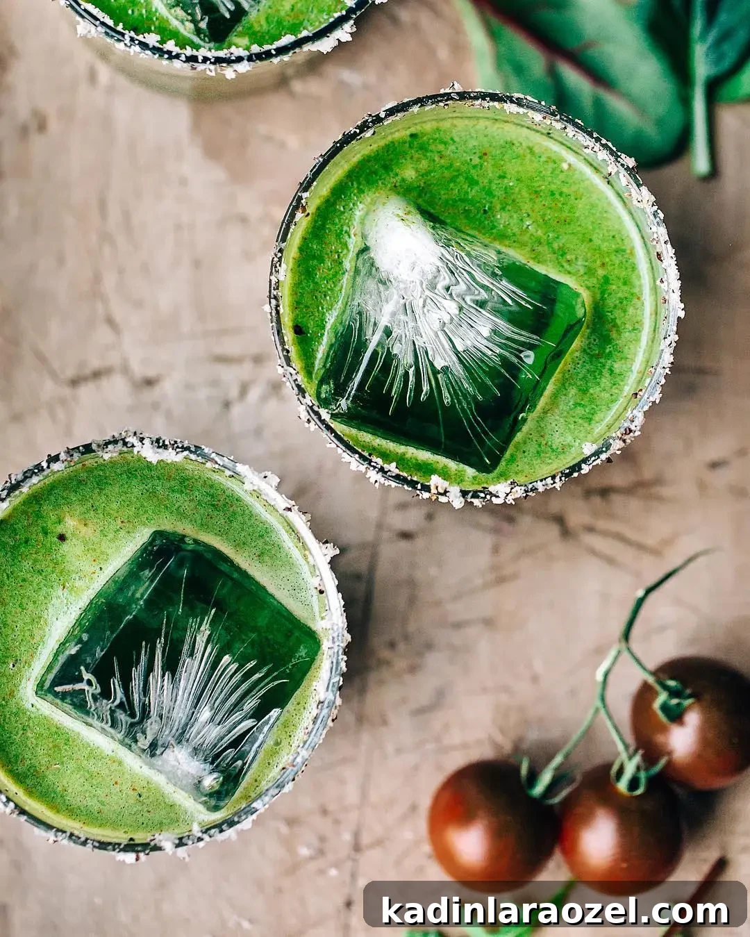 17 Refreshing Summer Cocktails to Try Now 9 bright green cocktail overhead, with large blocks of ice in short glasses