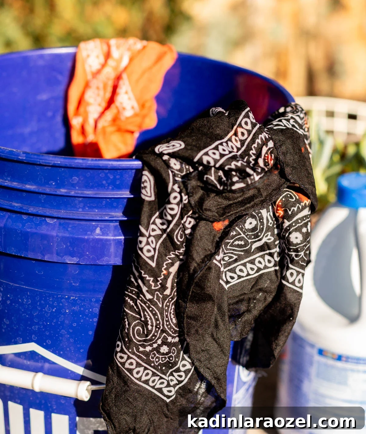 DIY Earth-Tone Bandanas: Stylish Patterns & Sewing Tips 5 black bandana in a bucket with bleach to dye it a new color